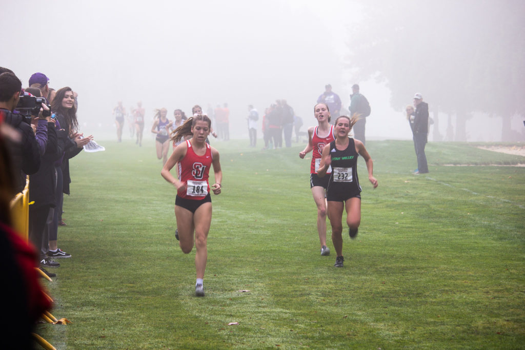 Megan Delorey and Rachel Kastama finishing in the Women's Cross Country WAC Championships.