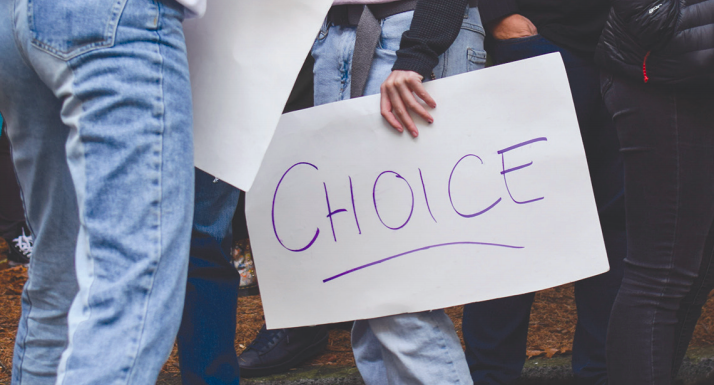 Student protestors hold signs outside the Administration Building.