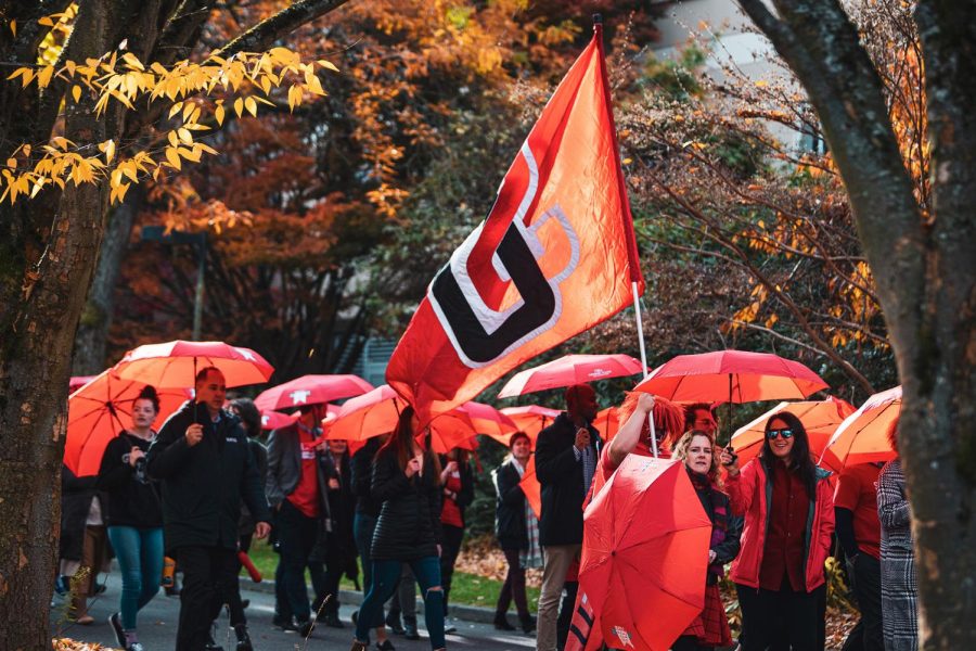 Seattle U community members march in the Red Umbrella Parade during Homecoming Week.