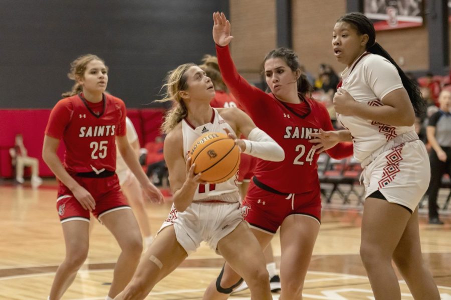 Junior Peyton Howard tries to put a shot up under heavy defense