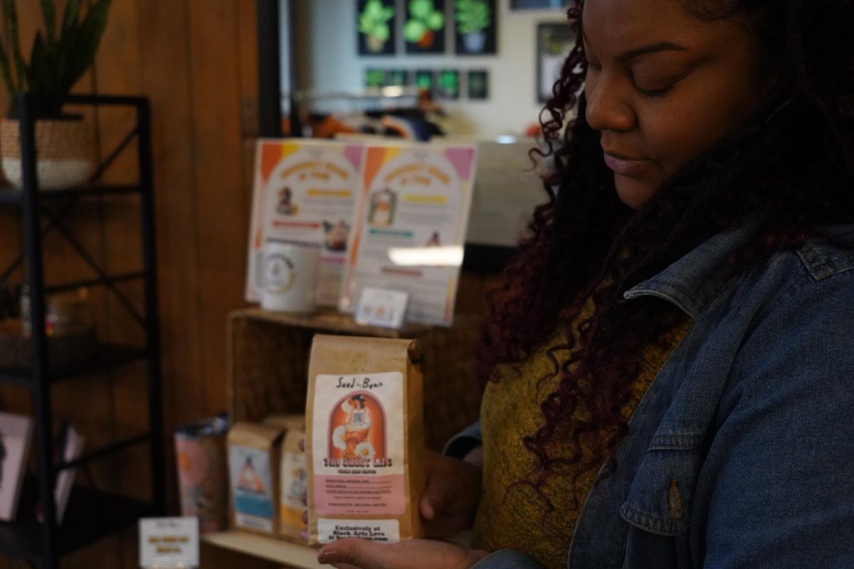 Bennett holds coffee from ‘Seed to Bean.'