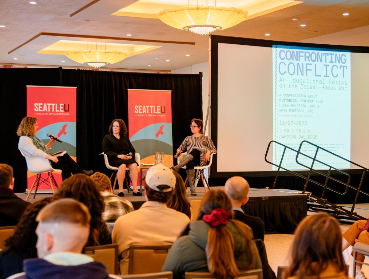 Moderator Beatrice Lawrence reading SU community’s questions for professors Liora Halperin and Nova Robinson during the Confronting Conflict event, a discussion of the historical context of the Israel-Hamas war.