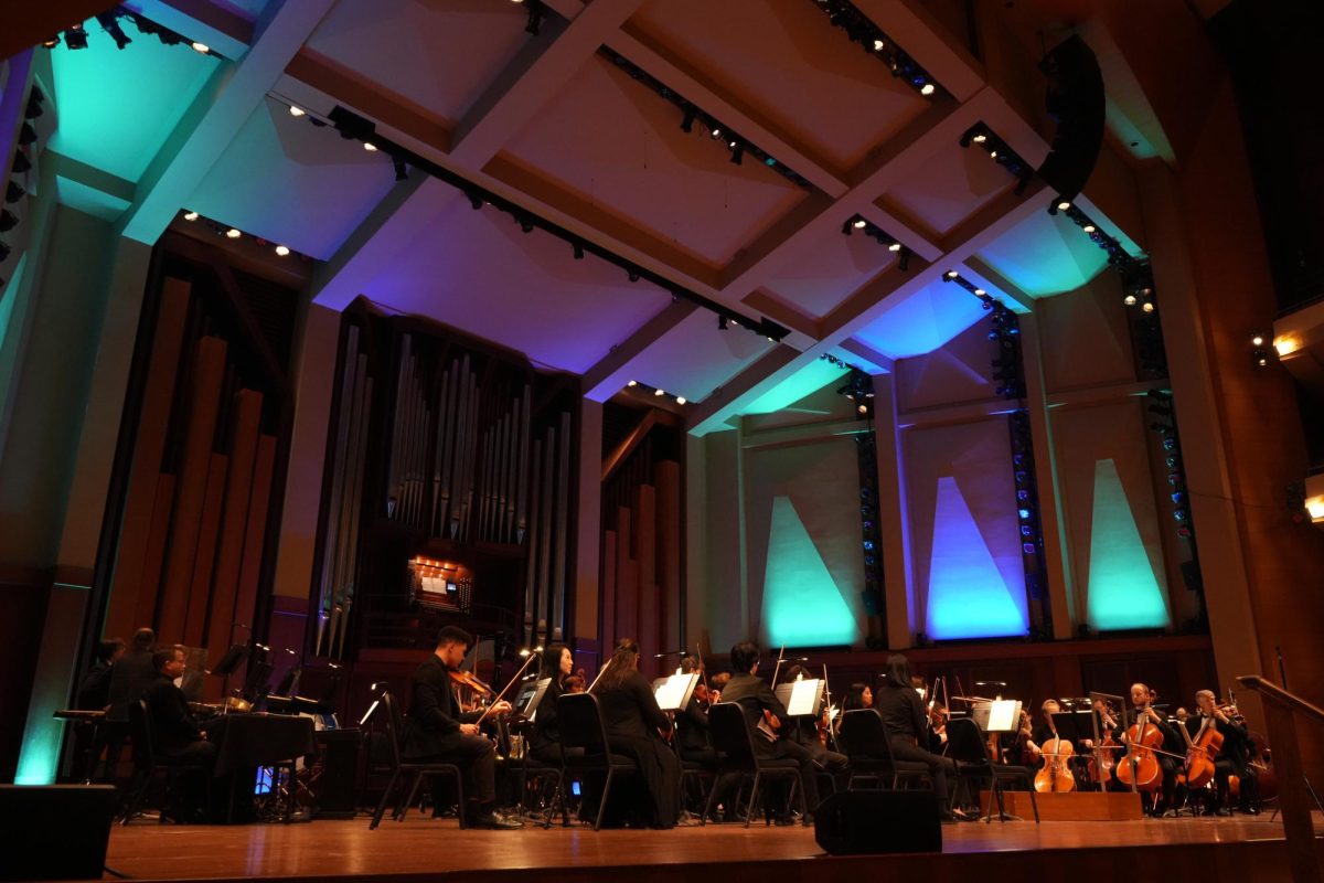 The orchestra tunes their instruments.